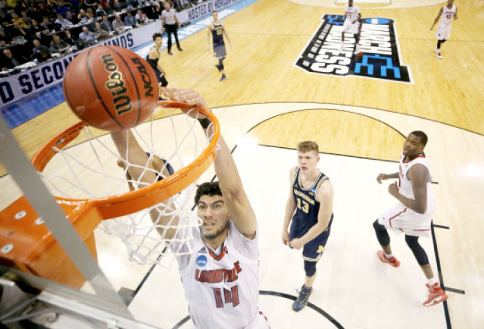 Anas Mahmoud No. 14 of the Louisville Cardinals shoots the ball against the Michigan Wolverines during the second round of the NCAA Basketball Tournament at Bankers Life Fieldhouse on Sunday in Indianapolis, Indiana. — AFP