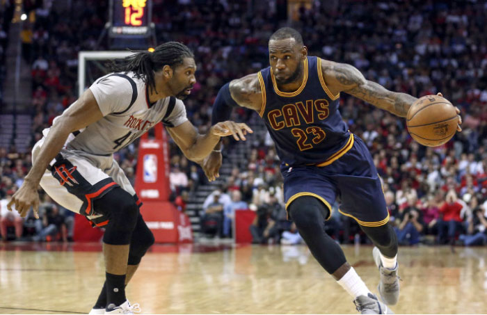 Cleveland Cavaliers forward LeBron James (23) dribbles the ball as Houston Rockets center Nene Hilario (42) defends during the third quarter at Toyota Center. — Reuters