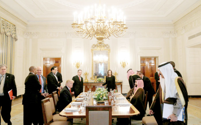 US President Donald Trump and Deputy Crown Prince Muhammad Bin Salman, second deputy premier and minister of defense, take their seats for lunch in the State Dining Room of the White House in Washington on Tuesday. — Reuters