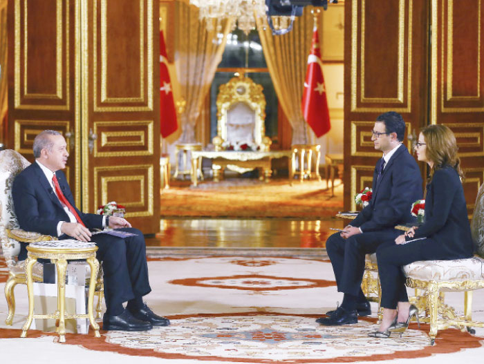 Turkey’s President Recep Tayyip Erdogan, left, speaks during an interview with A Haber television in Istanbul. — AP