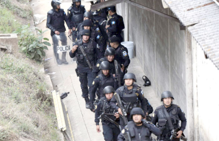 Riot police agents are pictured after the operation to rescue the four hostages kept held by inmates at the Stage II Male Juvenile Detention Center in San Jose Pinula, east of Guatemala City, on Monday. — AFP