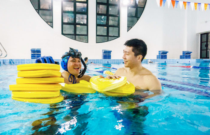 In this file photo, head coach Nowie Ignacio Cornelia (L), 37, from the Philippines, and geologist and former competitive swimmer Henry Chan (R), 28, who founded the “HK Typhoon” underwater hockey club, chat after their once-a-week team practice session at a 25-meter school pool in Hong Kong. — AFP