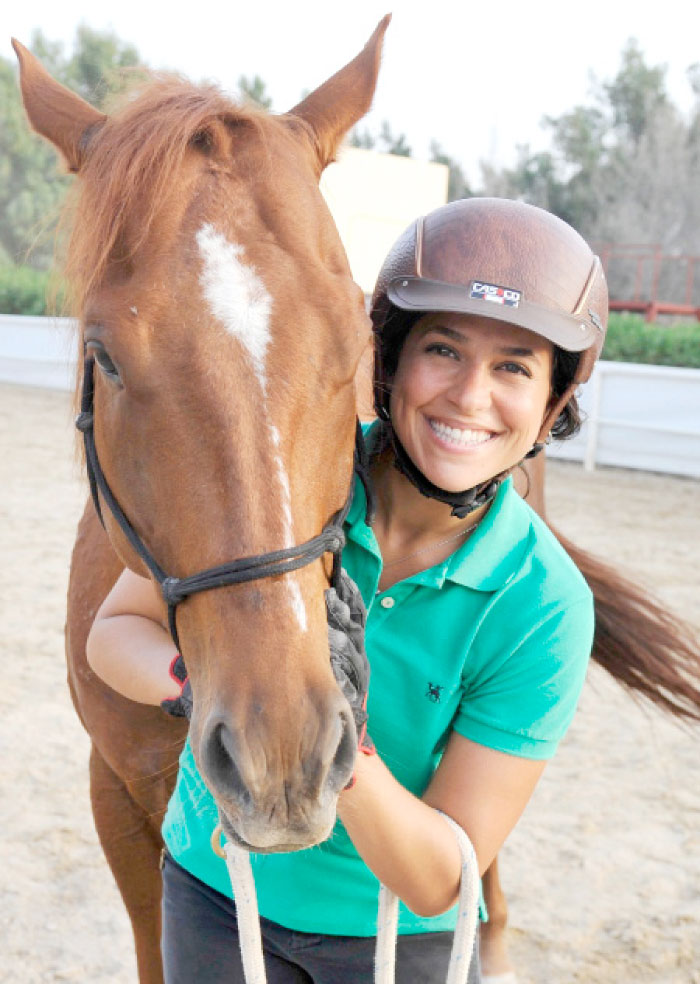 Dana Al-Gosaibi poses with a horse during a training session in Jeddah. — AFP