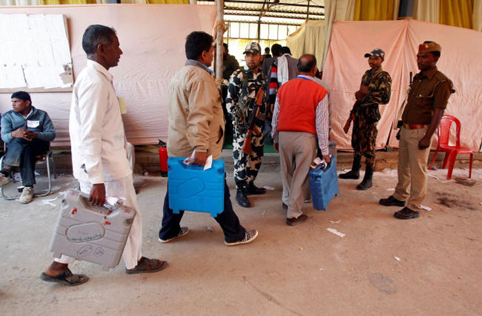 Election officials carry electronic voting machines (EVMs) as they arrive to count votes of the Uttar Pradesh assembly elections at a counting center in Allahabad, India Saturday. — Reuters