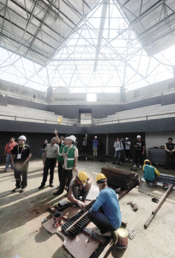 This photograph shows labourers working at a venue for the 2018 Asian Games at Senayan sport complex in Jakarta. The Olympic Council of Asia (OCA) warned Indonesia faces “huge” challenges to prepare for the 2018 Asian Games, criticizing a lack of coordination between different bodies organizing the event. — AFP