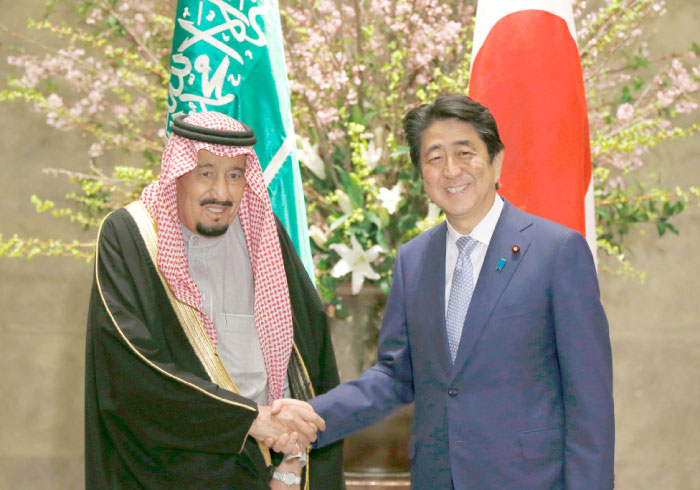 Custodian of the Two Holy Mosques King Salman and Japan’s Prime Minister Shinzo Abe shake hands before their meeting at Abe’s official residence in Tokyo on Monday. — AFP