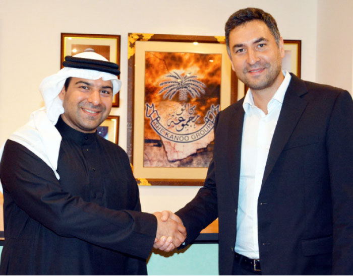 Fahad Fawzi Kanoo (left), representative of Yusuf Bin Ahmed Kanoo Group, and Idris Al-Rifai, co-founder of Fetchr shake hands after the deal