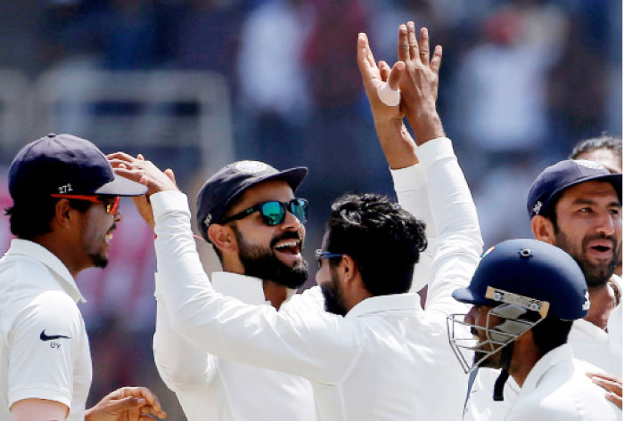 India’s captain Virat Kohli (C) celebrates the dismissal of his Australian counterpart Steven Smith with his teammates on the fifth and final day of the third cricket Test in Ranchi. — Reuters