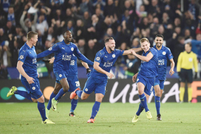 Leicester City’s midfielder Marc Albrighton (2nd R) celebrates scoring their second goal with teammates during their Champions League match against Sevilla at the King Power Stadium in Leicester Tuesday. — AFP