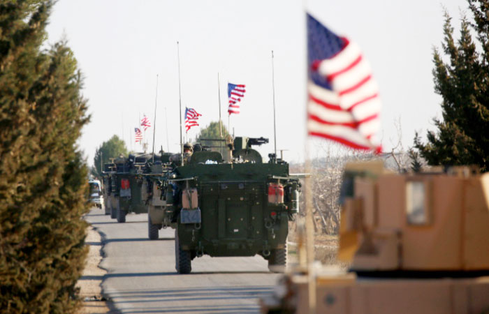 A convoy of US forces armored vehicles drives near the village of Yalanli, on the western outskirts of the northern Syrian city of Manbij. — AFP