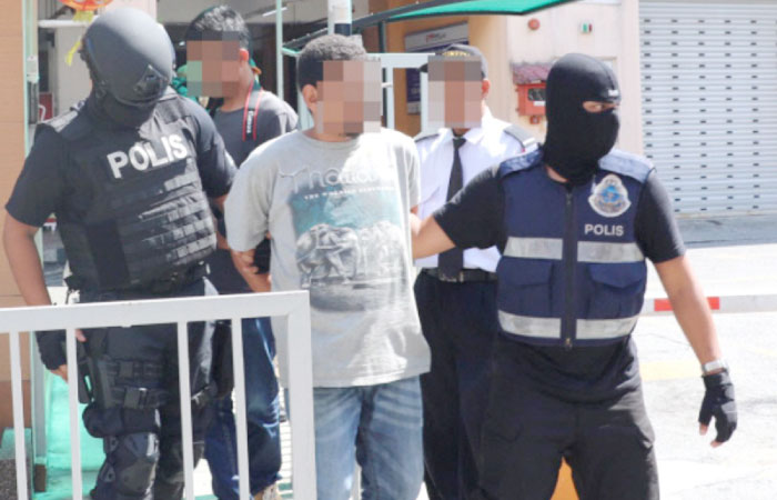 Malaysian police arresting a terror suspect.