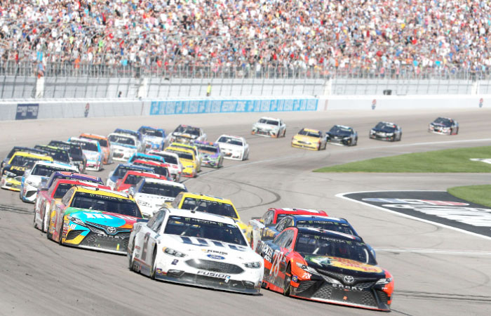 Martin Truex Jr., driver of the No. 78 Bass Pro Shops/Tracker Boats Toyota, and Brad Keselowski, driver of the No. 2 Miller Lite Ford, lead the field towards turn one during the Monster Energy NASCAR Cup Series Kobalt 400 at Las Vegas Motor Speedway on Sunday. — AFP