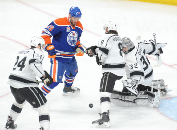 Los Angeles Kings goalie Jonathan Quick (32) battles for the puck with Edmonton Oilers center left winger Patrick Maroon (19). Kings defenseman Drew Doughty (8) and Kings defenseman Derek Forbort (24) help to block during the third period at Rogers Place. Oilers won the game 2-0. — Reuters