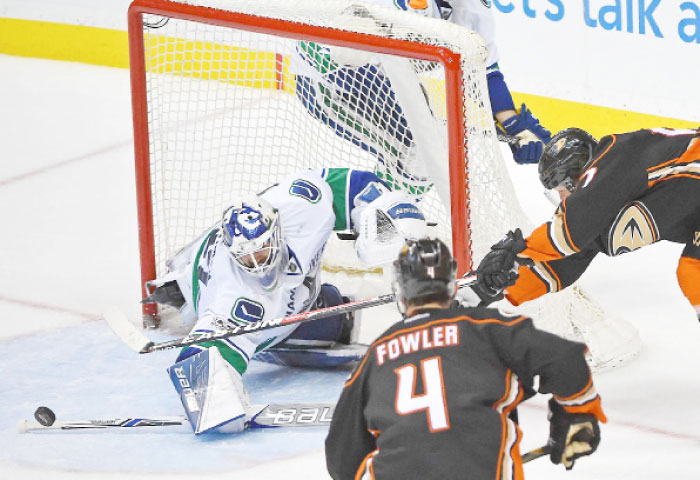 Vancouver Canucks goalie Richard Bachman (32) makes a save off a shot by Anaheim Ducks left wing Andrew Cogliano (7) in the third period of the game at Honda Center. — AFP