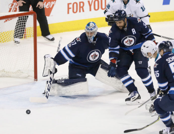 Winnipeg Jets goalie Connor Hellebuyck (37) makes a save during the second period against the San Jose Sharks at MTS Centre. — Reuters