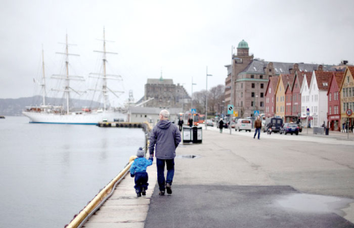 A man walks with a child near the marina in downtown Bergen, southwestern Norway. — Reuters file photo