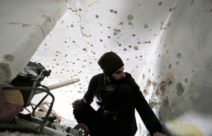 A Palestinian man inspects the damage at the home of 31-year-old Basel Al-Aaraj, who was killed by Israeli troops, in the West Bank city of Ramallah on Monday.  — AFP