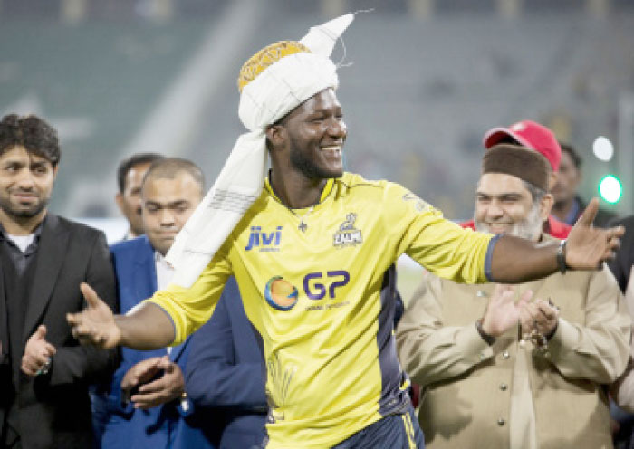 Former West Indies captain Darren Sammy gestures wearing a traditional turban at Gaddafi Stadium in Lahore Sunday. — AP
