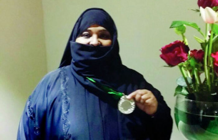 Jawhara Bint Hassan displays her medal. — Okaz photo