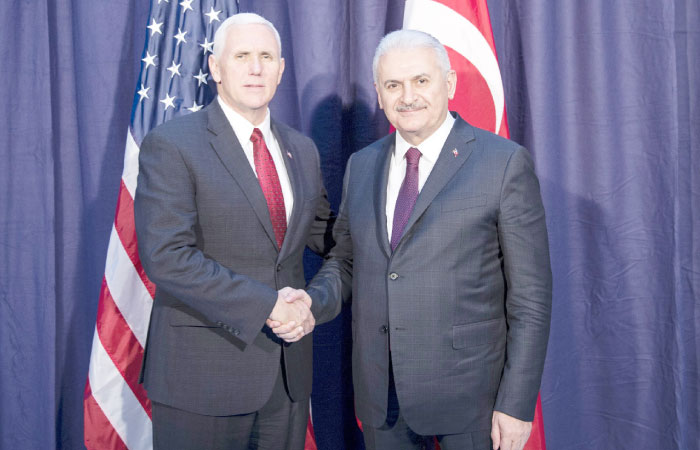United States Vice President Mike Pence, left and Turkey’s Prime Minister Binali Yildirim, right, shake hands for the photographers prior to their meeting during the Munich Security Conference in Munich, Germany. — AP