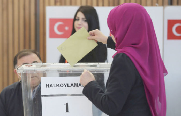 A woman casts her ballot in the referendum on a presidential system in Turkey in Fuerth, southern Germany, Monday. — AP