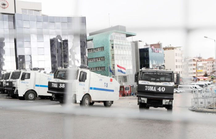 Anti-riot police vehicles form a blockade in a sealed off area surrounding the Dutch embassy (Rear C) in Ankara for “security reasons” as a crisis escalated between Turkey and The Netherlands after Turkey’s Foreign minister was barred from speaking in the country to promote a referendum at home. — AFP