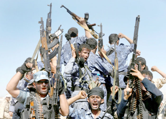 Houthi militias ride on the back of a truck during a parade in this file photo. — Reuters