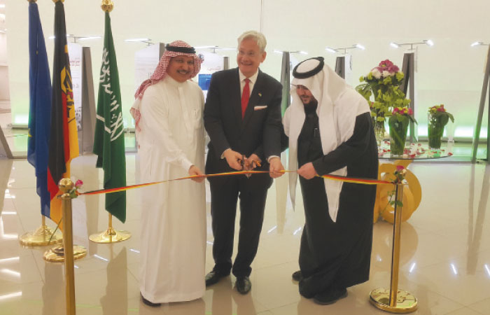 German Consul General Holger Ziegeler, Khalid Al Juffali (left) and an official of Al Hokair Group cutting the ribbon. — courtesy photo