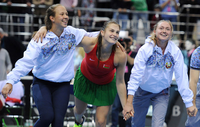 Belarus' Aryna Sabalenka (C) celebrates her victory over Switzerland's Viktorija Golubic with her teammates during the semifinals of the Fed Cup in Minsk Sunday. — AFP