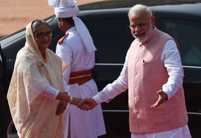 Indian Prime Minister Narendra Modi, right, shakes hands with Bangladesh Prime Minister Sheikh Hasina, left, during a ceremonial reception at Presidential house in New Delhi on Saturday. — AFP