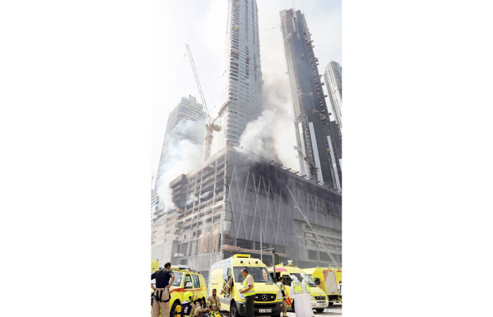 Members of the Dubai Civil Defence arrive at the scene of a fire which broke out in a construction site near the Dubai Mall and Burj Khalifa, the world’s tallest building, and burned for several hours in Dubai on Sunday. — AFP