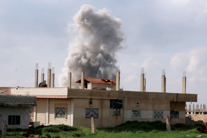 Smoke rises after an air strike on rebel-held Daraa Al-Balad, Syria. — Reuters