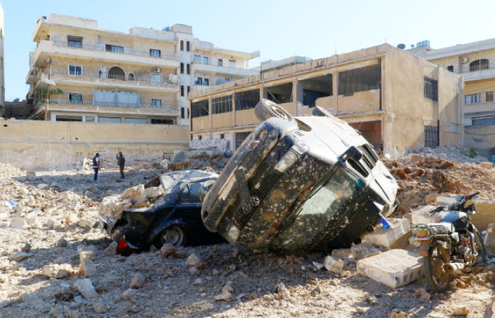 Damaged vehicles and hospital are pictured on Tuesday at a site hit by overnight air strike in Kafr Takharim, northwest of Idlib city, Syria. — Reuters