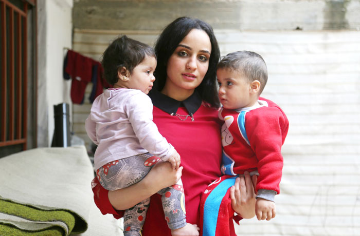 Twenty-three year old Islam Maytat from Morocco poses for a photo with her children Maria (L) and Abdullah in the Kurdish-majority city of Qamishli in northern Syrian after she escaped from Daesh group territory following three traumatic years living in the group’s so-called “caliphate”. — AFP