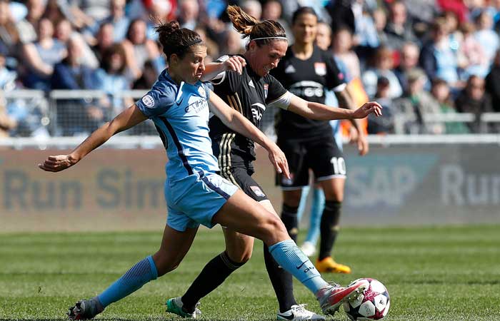 Manchester City's Carli Lloyd, left, battles for the ball with Olympique Lyonnais' Camille Abily during the Women's Champions League semifinal, first leg soccer match at the Academy Stadium, Manchester, England, Saturday. — AP