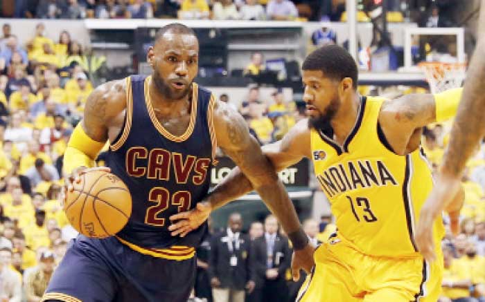 Cleveland Cavaliers’ LeBron James (L) drives past Indiana Pacers’ Paul George in Game 3 of the NBA playoffs at Bankers Life Fieldhouse in Indianapolis Thursday. — Reuters