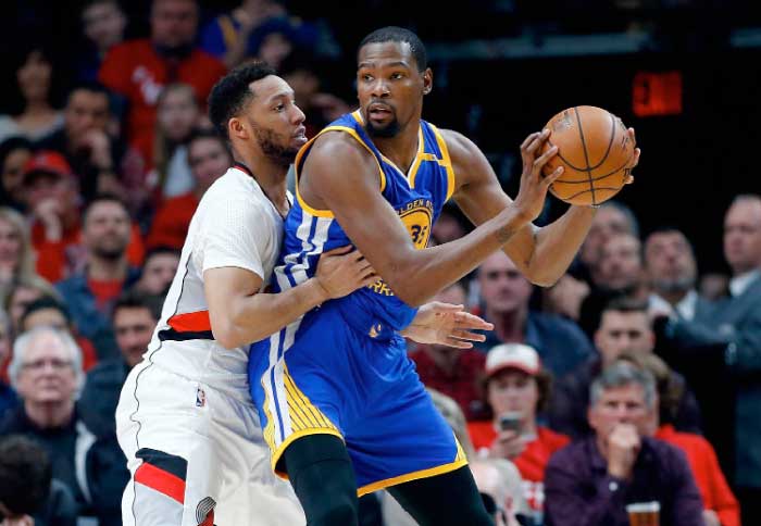 Kevin Durant No. 35 of the Golden State Warriors is guarded by by Maurice Harkless No. 4 of the Portland Trail Blazers during Game Four of the Western Conference Quarterfinals of the 2017 NBA Playoffs at Moda Center on Monday in Portland, Oregon. — AFP