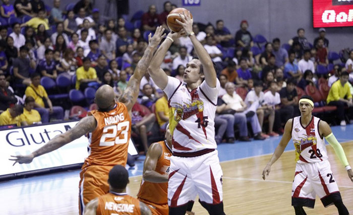 San Miguel Beer's June Mar Fajardo fires a shot off Meralco's Kelly Nabong in their PBA Commissioner's Cup game at the Smart-Araneta Coliseum Sunday night.