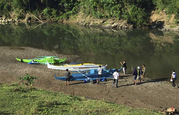 People stand by boats which the military said were used by Abu Sayyaf militants to enter the Ibananga River in Bohol province, central Philippines, in this April 12, 2017 file photo. — AP