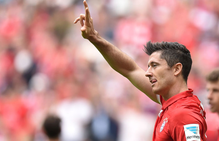 Bayern Munich's striker Robert Lewandowski celebrates after scoring against Augsburg during the German first division Bundesliga football match in Munich Saturday. — Reuters