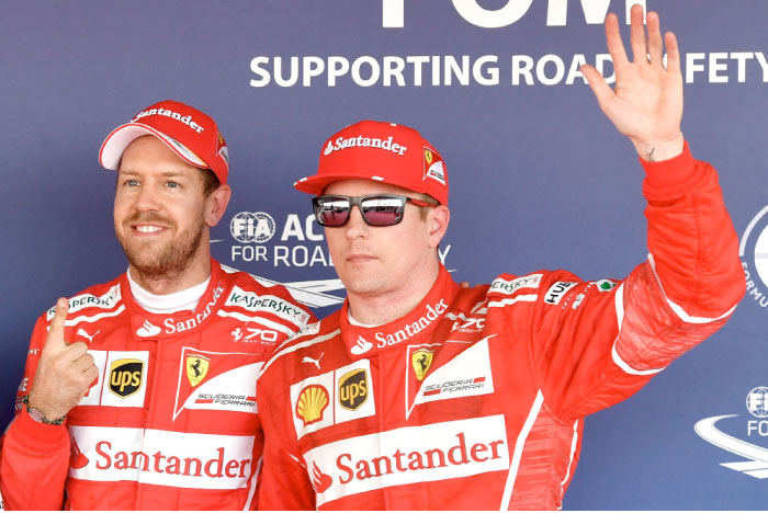 Pole position winner Ferrari’s German driver Sebastian Vettel (L) celebrates next to second-placed Ferrari’s Finnish driver Kimi Raikkonen after the qualifying session for the Formula One Russian Grand Prix in Sochi Saturday. — AFP