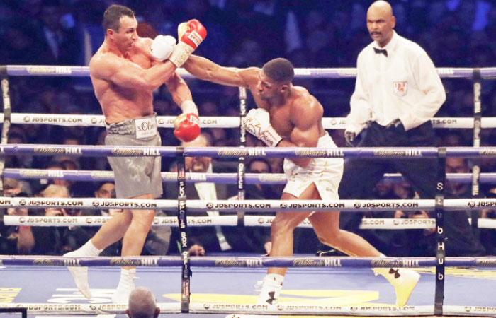 Anthony Joshua (R) of Britain fights Wladimir Klitschko of Ukraine at the Wembley Stadium in London Saturday. — AP