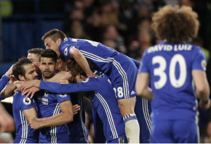 Chelsea’s Diego Costa celebrates scoring their third goal with teammates against Southampton during their Premier League match at Stamford Bridge Tuesday. — Reuters