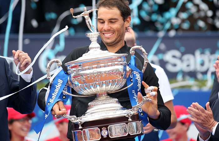 Rafael Nadal of Spain holds up the trophy after beating Dominic Thiem of Austria in the final of the Barcelona Open in Barcelona Sunday. — Reuters