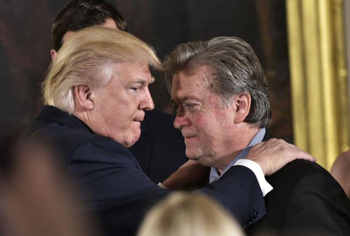 US President Donald Trump, left, congratulates senior counselor Stephen Bannon during the swearing-in of senior staff in the East Room of the White House in Washington, DC, in this Jan. 22, 2017 file photo. — AFP