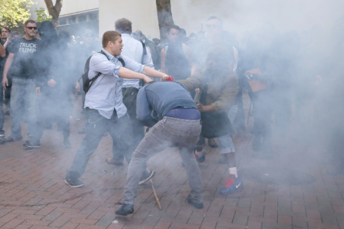 Trump supporters clash with protesters at a “Patriots Day”  free speech rally on Saturday in Berkeley, California. — AFP