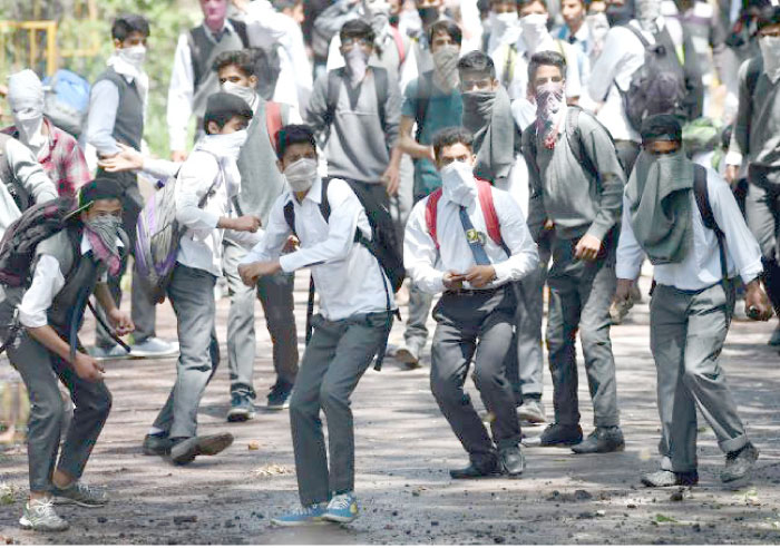 Kashmiri students clash with Indian government forces in central Srinagar’s Lal Chowk on Monday. — AFP