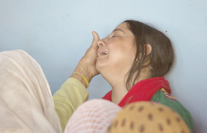 A woman tries to comfort wife Ankita Sharma, right, as they await the arrival of the body of Indian paramilitary soldier Sanjay Kumar at his home in Palampur, about 40 km south of Dharmsala, India, on Tuesday. — AP