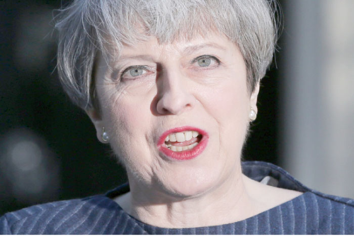 British Prime Minister Theresa May speaks to the media outside 10 Downing Street in central London on Tuesday. — AFP