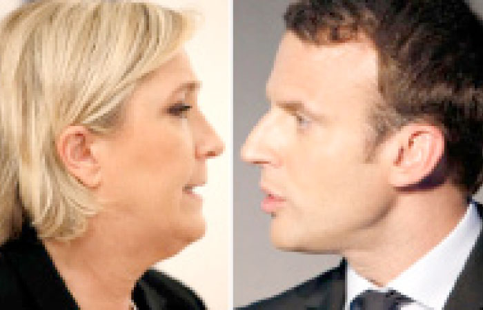 A combination picture shows portraits of candidates for the second round in the 2017 French presidential election, Marine Le Pen (L), French National Front (FN) political party leader, and Emmanuel Macron, head of the political movement En Marche!, (Onwards!). — Reuters